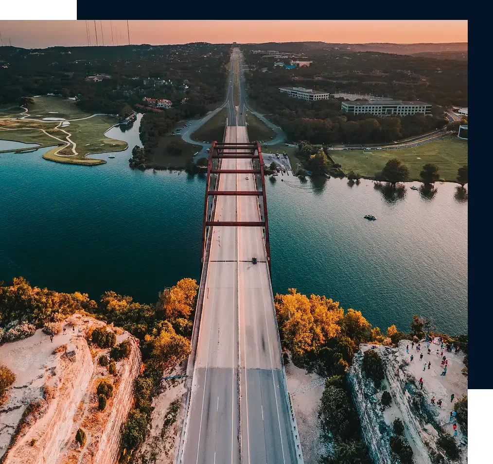 Austin's Pennybacker Bridge, aerial shot. There is one car driving on the bridge.